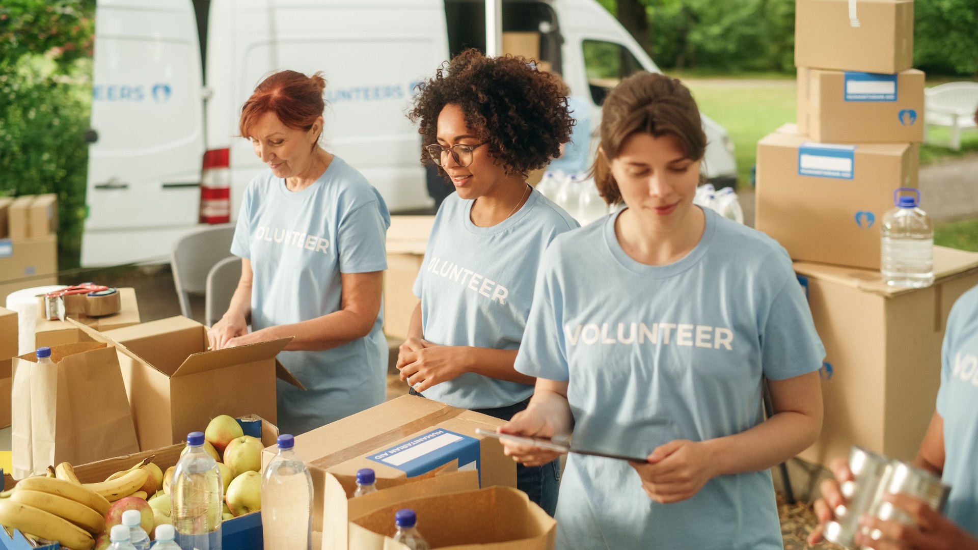 Group of Volunteers Preparing Free Food Rations for Poor People in Need. Charity Workers and Members of the Community Work Together. Concept of Giving, Humanitarian Aid and Society.